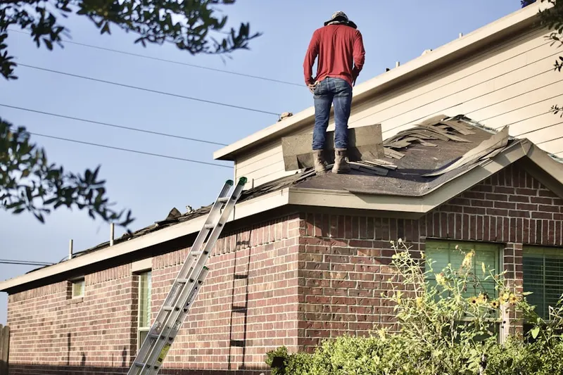 Professional roofer working on a residential roof in Poinsetta